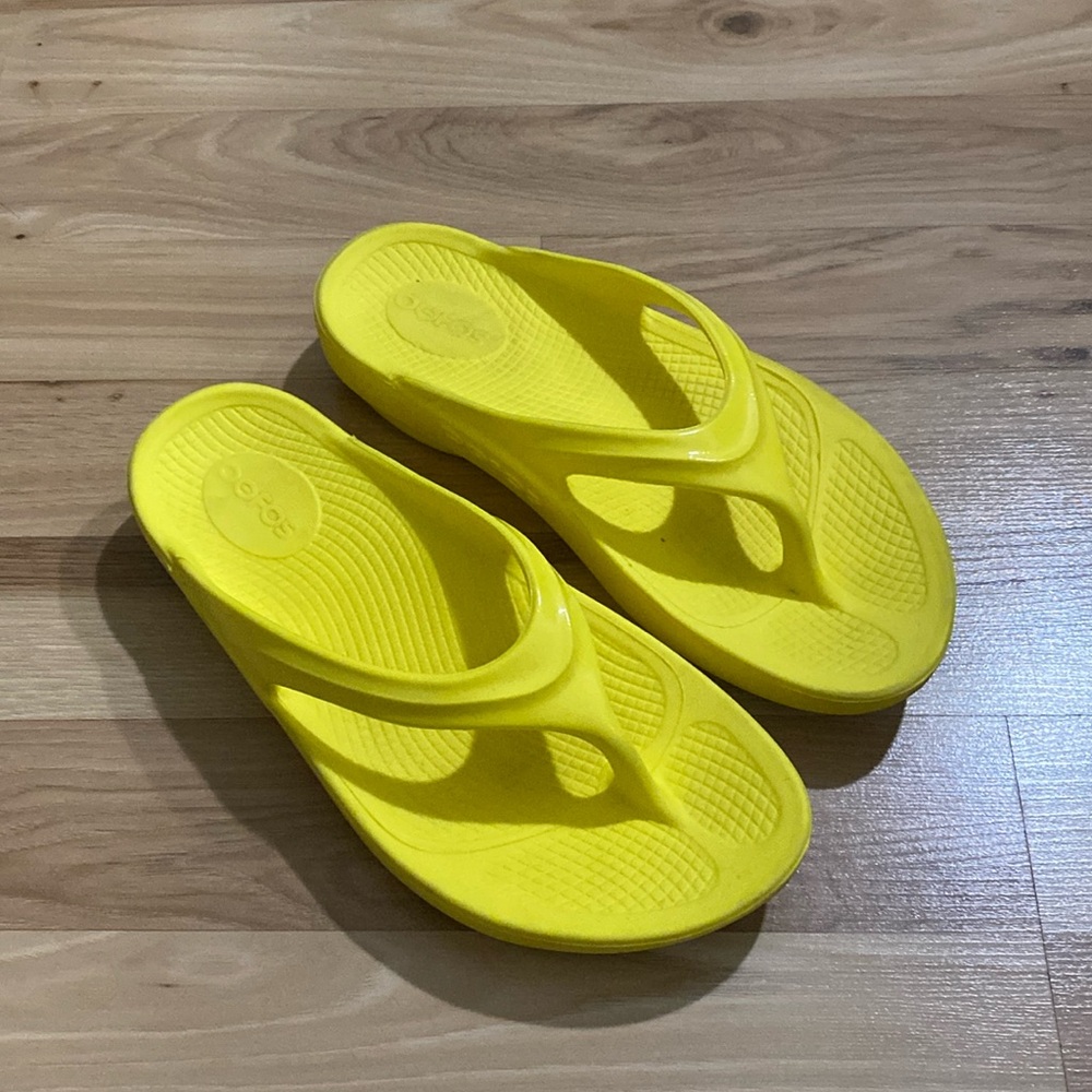 Yellow oofos flip flops